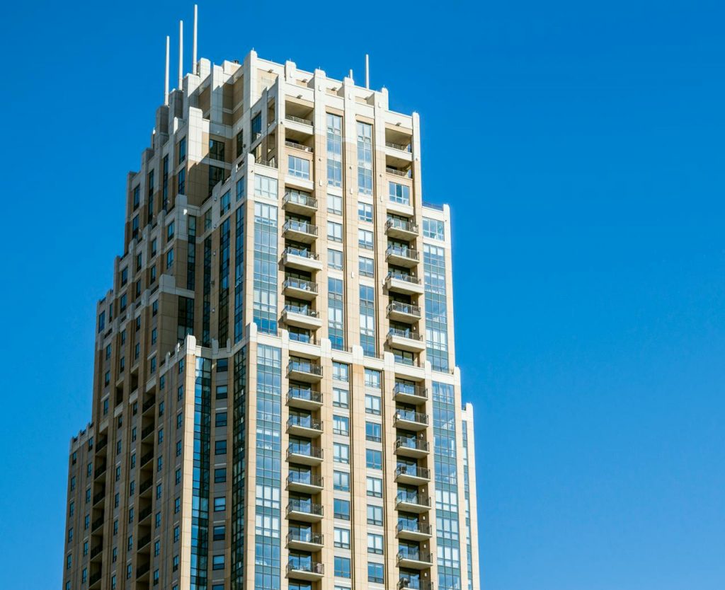 A striking architectural skyscraper with a modern facade under a clear blue sky.